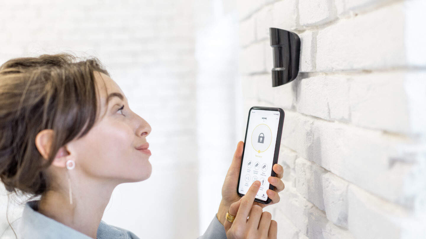 woman controlling her alarm system from her mobile phone